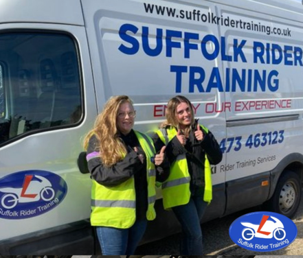 Two students outside an SRT van